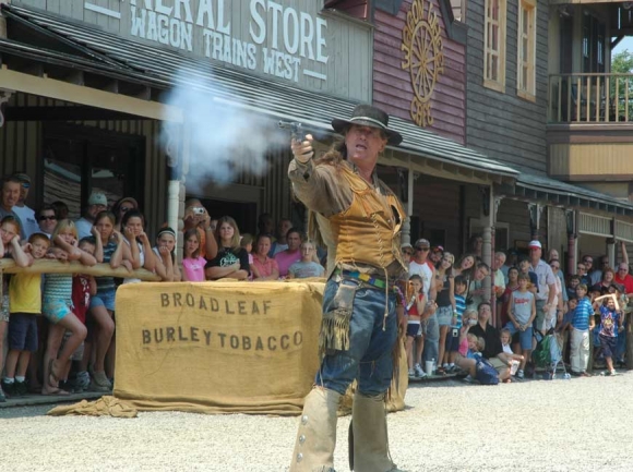 Visitors watch intently as one of Ghost Town’s performers participates in a mock gunfight in 2007. File photo
