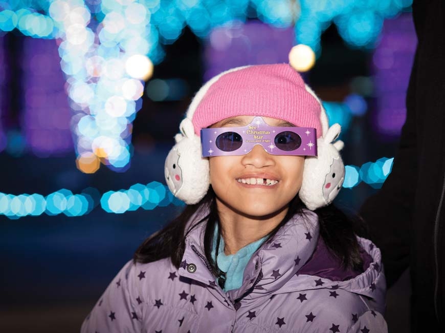 A young guest enjoys last year’s light show. Cami Calnan photo