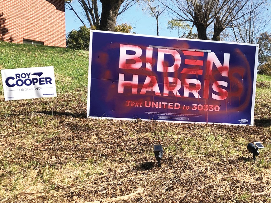 A Biden/Harris sign (left) at a private home on Russ Avenue in Waynesville was defaced earlier this week. Donated photo