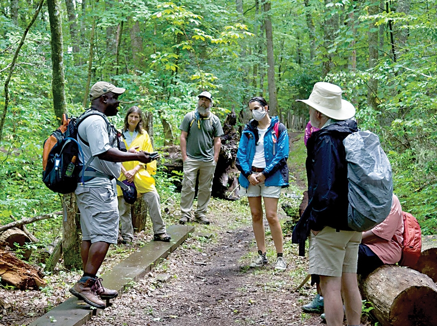 Cash addresses hike participants on the trail. NPS photo