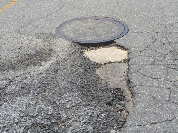 Canton’s proposed vehicle fee could be used to fill potholes like these, on Holtzclaw Road. Cory Vaillancourt photo