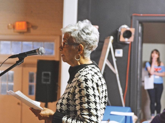 Alice Lowery (foreground) speaks to the crowd at the Poor People’s Town Hall while event organizer Chelsea White looks on from backstage. Cory Vaillancourt photo