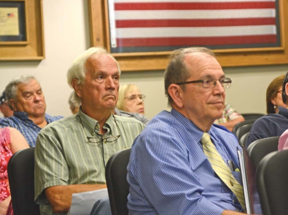 Dr. Cliff Faull (green shirt), a member of the former consolidated board, listens to public comment Oct. 1. Holly Kays photo