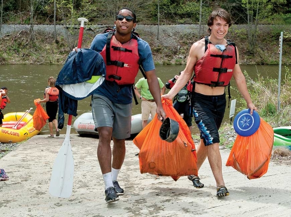 Volunteers carry full bags of trash after participating in a previous Tuck River Cleanup. WCU photo