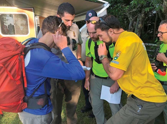 Searcher leaders huddle at the command post. NPS photo