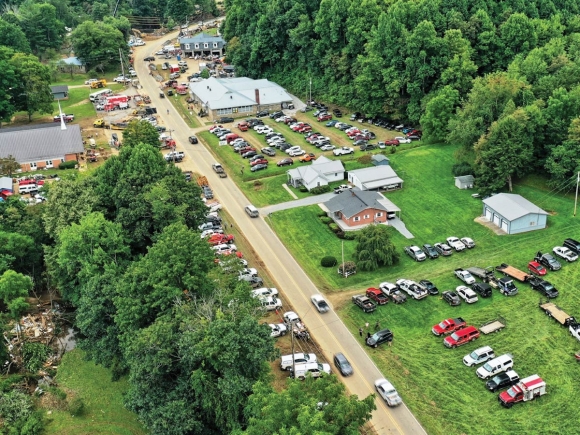 Volunteers and first responders gather in Cruso on Saturday to make plans for recovery efforts after the flood Tuesday. A Shot Above WNC