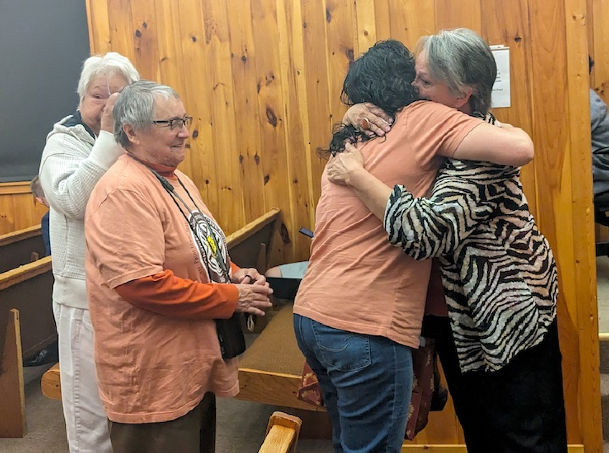 Big Cove Rep. Teresa McCoy hugs members of the Community Club Council following Tribal Council’s vote to put the proposed constitution out for referendum April 6. Holly Kays photo