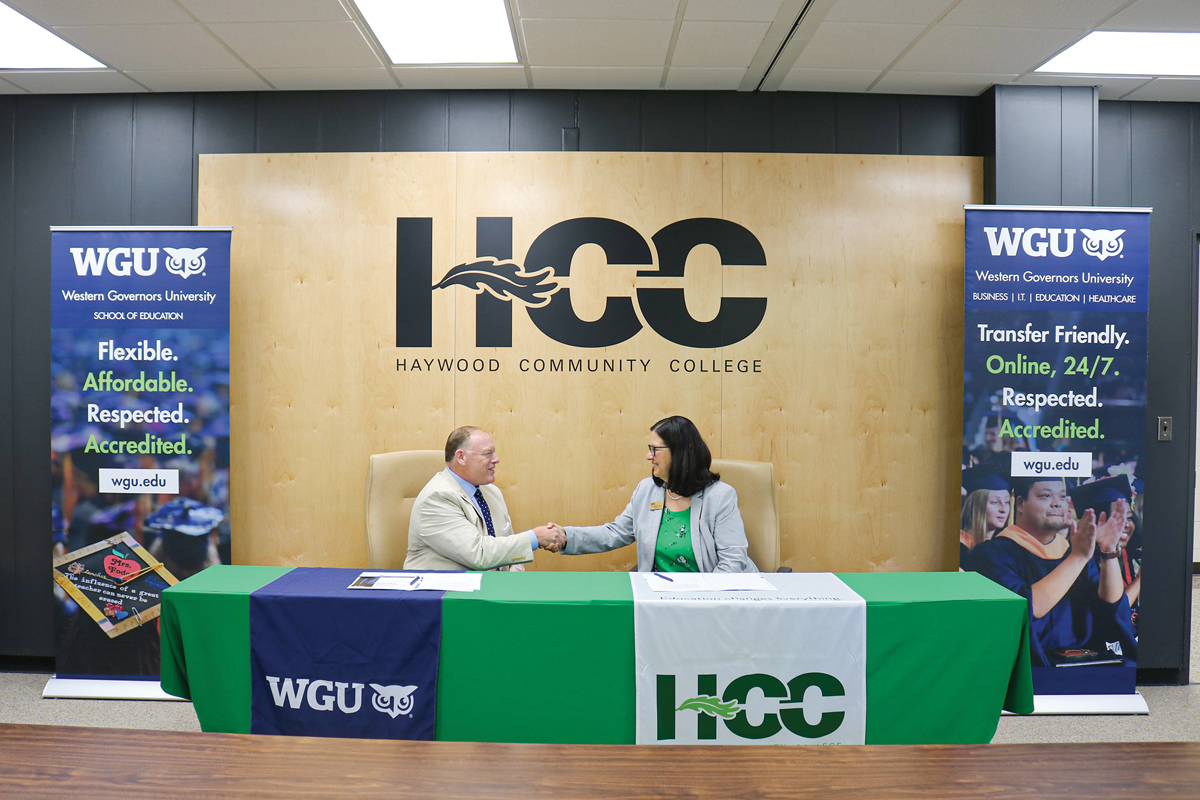 WGU North Carolina Chancellor Ben Coulter and HCC President Shelley White shake hands after signing the agreement. Donated photo