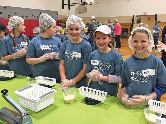 Junaluska Elementary School students work together to package meals for Rise Against Hunger. Jessi Stone photos