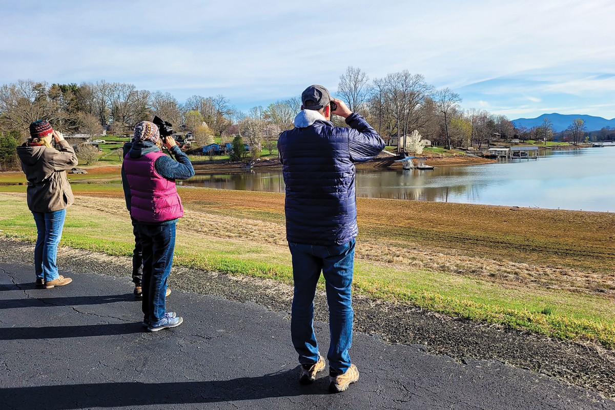 Birders watch the lake for avian residents. MountainTrue photo