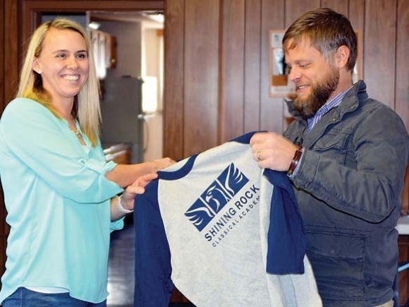 Shining Rock Classical Academy Board Chair Anna Eason (left) welcomes Nathan Duncan to the head of school job Jan. 23, 2018.