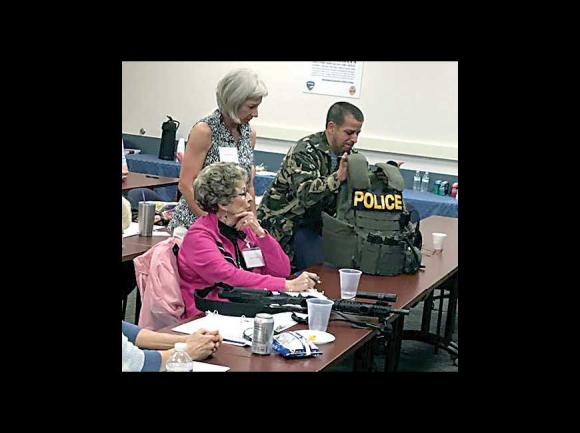 Students in the Waynesville Civilian Police Academy inspect tactical gear. Donated photo