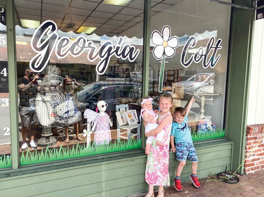 Georgia, Colt and Daisy Coble pose in front of their dad’s new store.