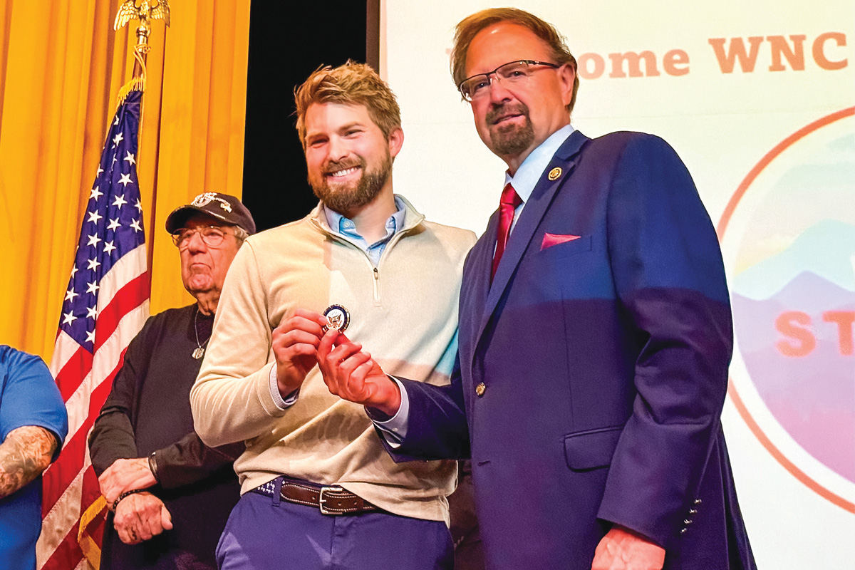 Influencer Matt Von Swol (left) receives a medallion from Rep. Chuck Edwards (R-Henderson) at the NC-11 GOP district convention at Tuscola High School on April 26. Cory Vaillancourt photo
