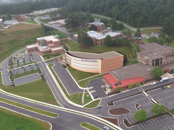 An artist rendering shows how the new building (center) will fit into the existing campus. Donated graphic  