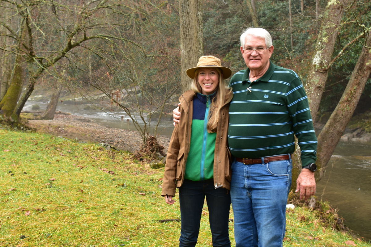 Jess Laggis of the Southern Appalachian Highlands Conservancy stands with a landowner on one of the many farmland  conservation projects the nonprofit has worked on. SAHC photo