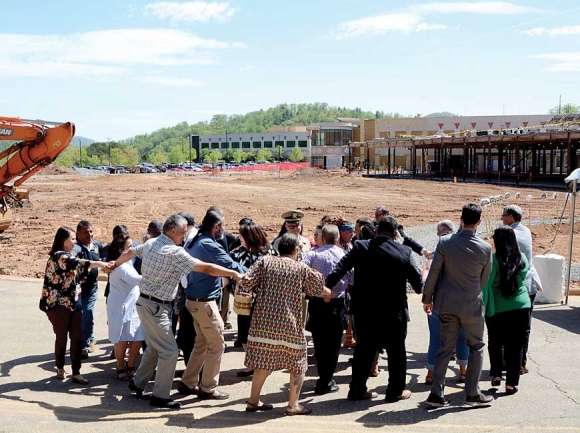 Groundbreaking attendees participate in a Cherokee Friendship Dance (above) immediately before witnessing the first shovelfuls of dirt being turned. Bo Crowe, executive director of the Museum of the Cherokee Indian, greets the crowd (below) to begin the program April 24. Holly Kays photos