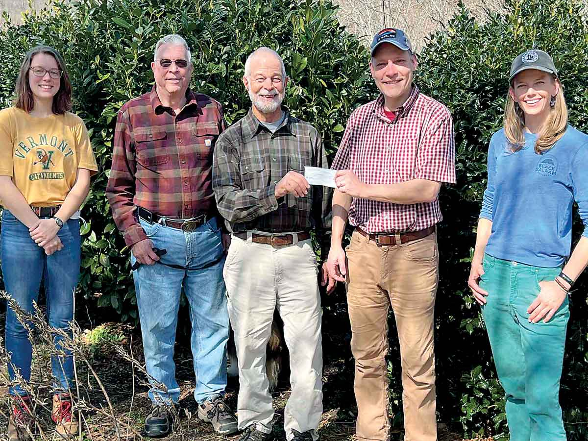 Burt Kornegay (center) hands the donation check to Friends of Panthertown Executive Director Jason Kimenker, joined by (from left) Friends of Panthertown Stewardship Manager Kara McMullen, Friends of Panthertown Vice President Mike Purdy and Friends of Panthertown Trails and Stewardship Director Krista Robb. Donated photo