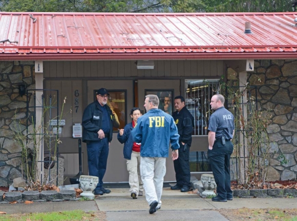 FBI agents take documents from the Qualla Housing Authority headquarters during a February 2017 raid. Holly Kays photo 