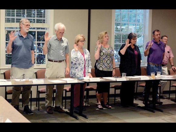 Board members take their oath of office during the board’s inaugural meeting June 11. Jerry DeWeese (second from right) would resign this position within the hour. Holly Kays photo