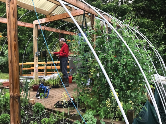 Houghton tends his summer garden, plastic lowered for the season. Donated photo