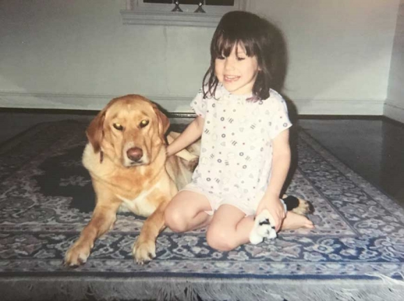 Taylor Sexton at five years old, found happiness in dogs despite the trauma she was going through at the time.