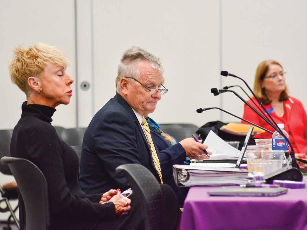 State Auditor Beth Wood (left) and Treasurer Dale Folwell (center) review their notes as Chancellor Kelli R. Brown (right) looks on during a Nov. 1 meeting of the Local Government Commission in Cullowhee. Cory Vaillancourt photo