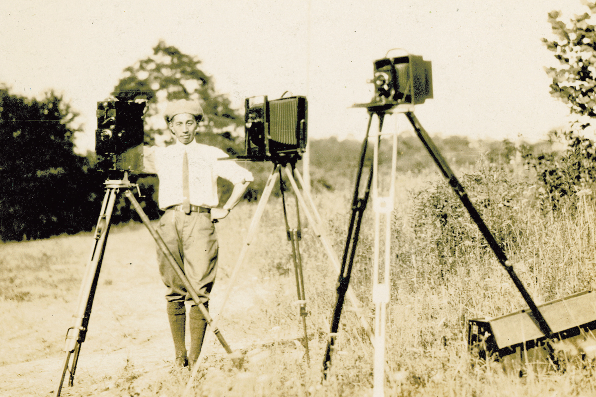 George Masa strikes a pose with three of his cameras. George Masa photo