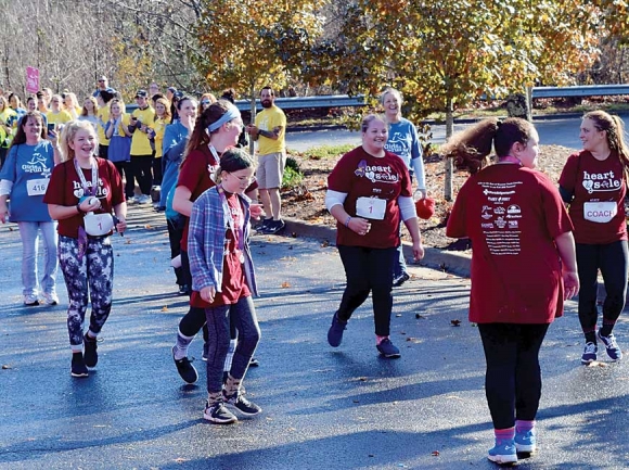 Jaylyn Logan, an eighth-grader at the new Catamount School in Sylva, approaches the finish line of the Girls on the Run 5K race with her teammates in December. Donated photo