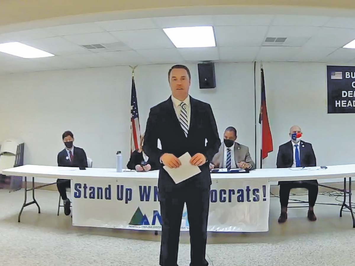 NC-11/14 Democratic Party Chair Matt Ballance (center) speaks before a Jan. 8 forum. Facebook photo