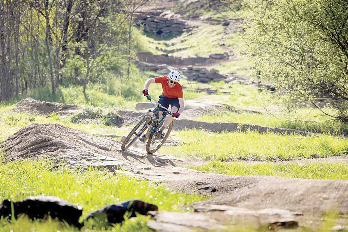 A mountain biker curves along a trail in Berm Park, the mountain biking skills course within Canton’s Chestnut Mountain Nature Park. 