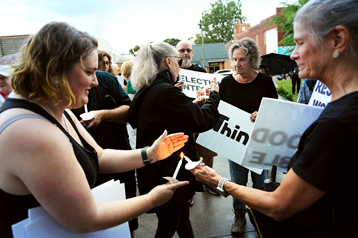 Demonstrators light candles in memory of the late John Lewis on July 17, 2025.