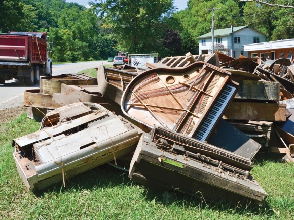 Some 9 tons of piano lies piled up in the sun outside Ward Piano on Asheville Highway, outside Canton. Cory Vaillancourt photos