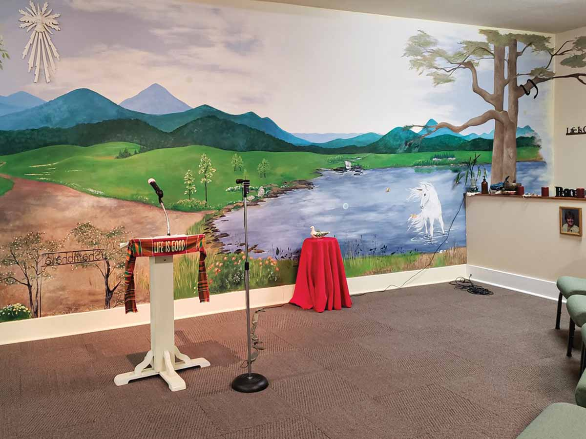The front wall of the Creative Thought Center sanctuary is decorated with a landscape mural. Kim Walzer photo