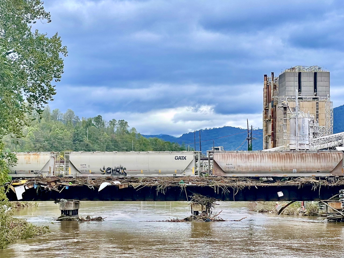 Storm debris lines a railroad bridge (foreground) leading to Pactiv Evergreen&#039;s Canton mill on Saturday, Sept. 28.