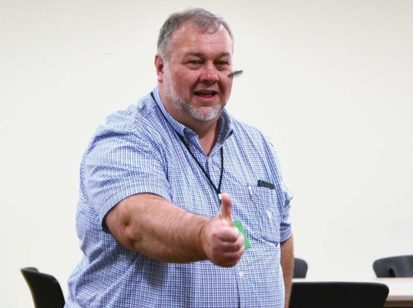 Elections Chairman Kirk Stephens throws a silver dollar in the air. Cory Vaillancourt photo