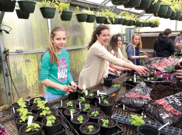 Students pot up plants for the plant sale. Donated photo