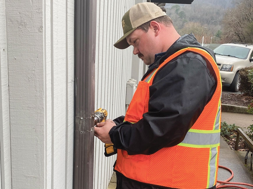 Zach Sorrells repairs the gutters at Sylva Town Hall. Donated photo