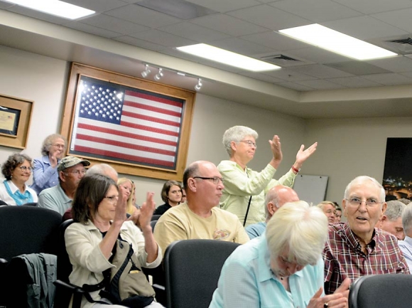 Members of the public applaud following a unanimous vote to support the conservation project. Holly Kays photo