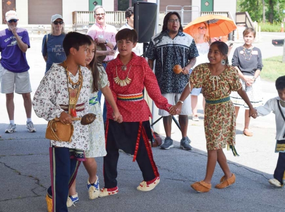 Cherokee children lead a traditional friendship dance at the Nikwasi Mound in Franklin. Barbara McRae (below, left) and Juanita Wilson, co-chairs of the Nikwasi Initiative, give the opening prayer in English and Cherokee. Jessi Stone photos