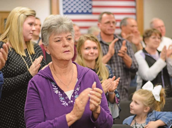 Members of the community opposed to Sunday morning alcohol sales applaud following public comment from one of the many anti-alcohol speakers who spoke during a public hearing March 19. Holly Kays photo