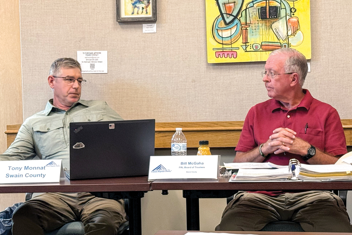 Former FRL board Vice Chair Tony Monnat and newly elected Chair Bill McGaha share a look while debating the diversity statement in the library card application. 