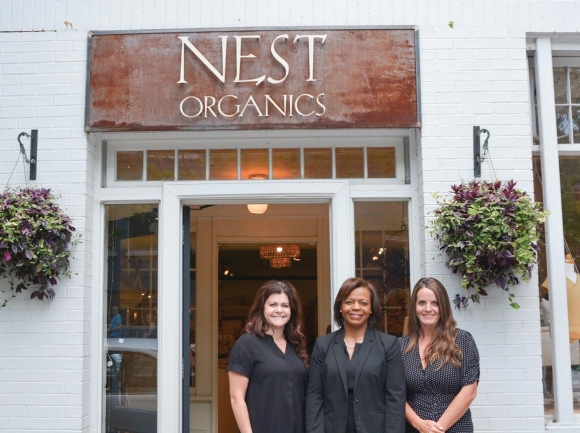 Cheri Beasley visits with Lyndsey Marlar and Katie Spears, owners of Nest Organics in Asheville. Hannah McLeod photo