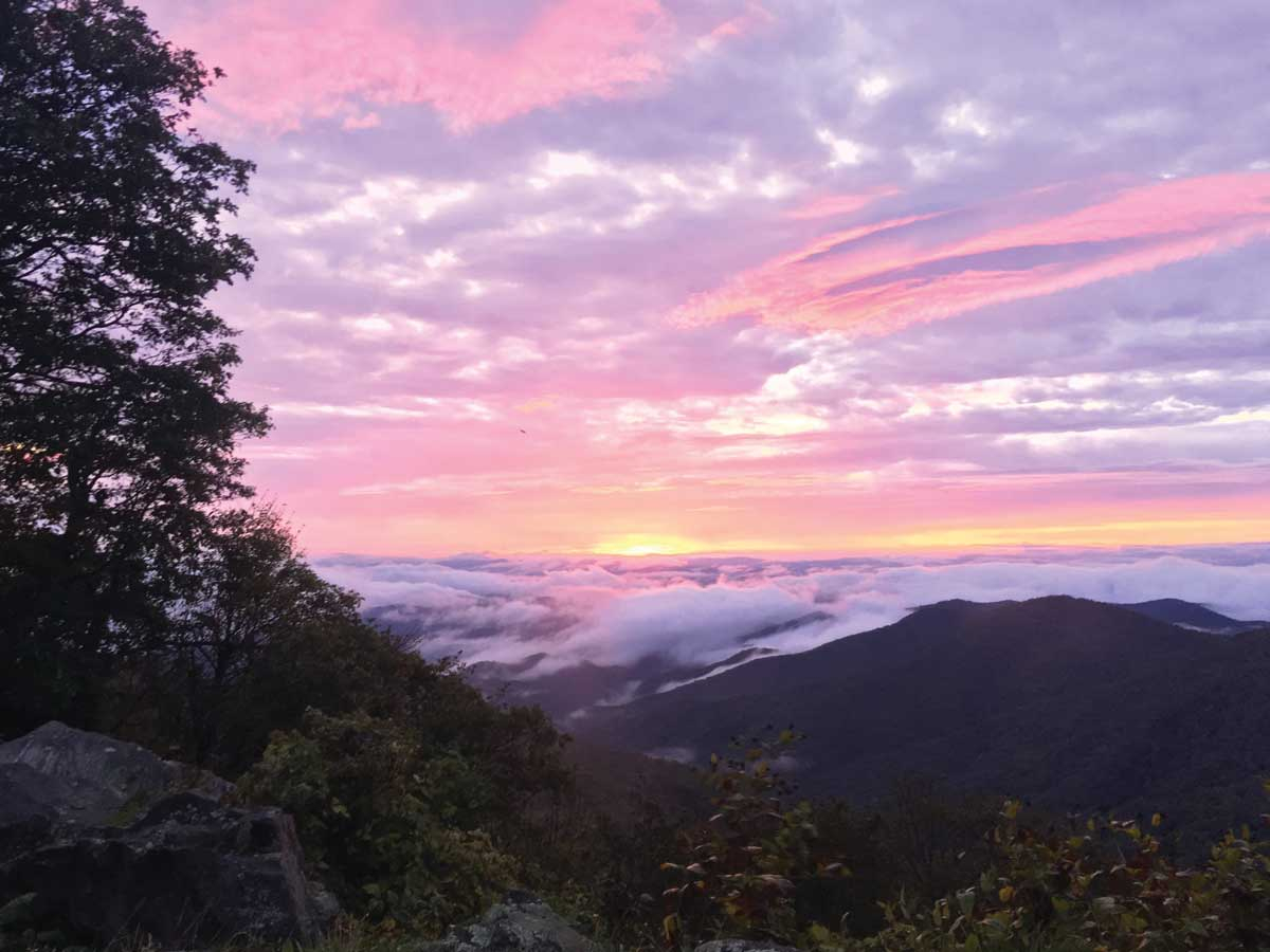 As the sun hits the horizon, it shoots color through the sky from a viewpoint on the Pisgah Ranger District. USFS photo