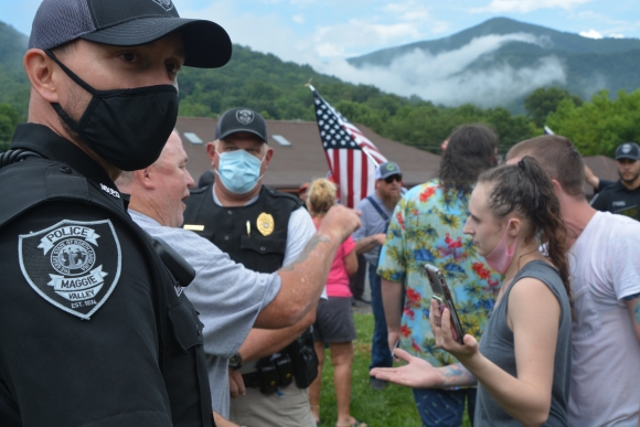 Demonstrators and counterdemonstrators argue under the watchful eye of the Maggie Valley Police Department on July 18