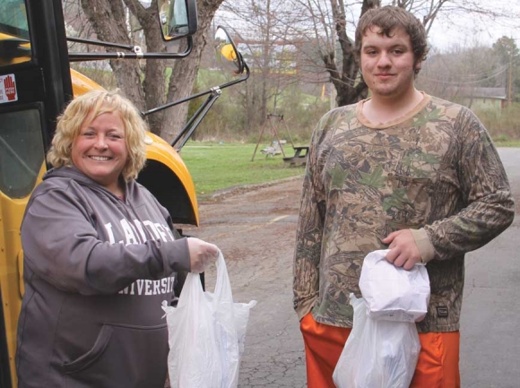 Angela Lunsford, principal of Jackson Community School, helps deliver meals to students this week. She is assisted by JCS senior Ryan Bailey. Donated photo 
