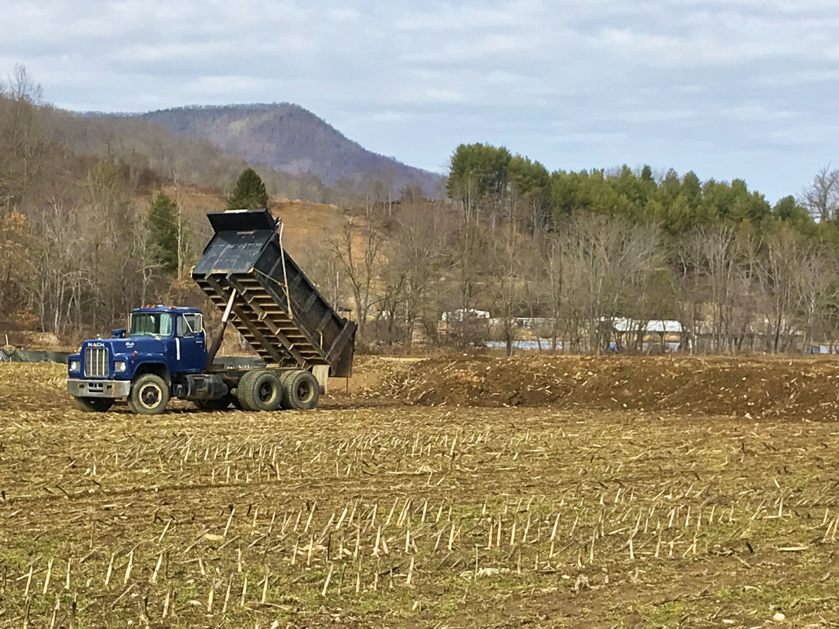A dump truck spreads dirt — not misinformation — on the Jonathan Creek parcel in January, 2018.
