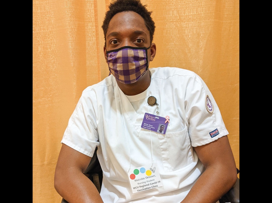 Malcolm Skinner, a nursing student at Western Carolina University, is getting hands-on experience in his chosen profession by working at the school’s COVID-19 vaccine clinic. Holly Kays photo