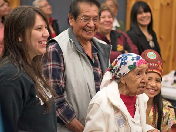 Amanda Swimmer’s family members, standing around her, laugh as she cracks a joke during her remarks following Tribal Council’s decision to name her a Beloved Woman. Holly Kays photo 