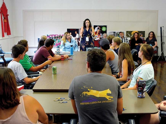 Group Relations Coordinator Elizabeth Burson (standing) takes Folkmoot guides through a training session. Cory Vaillancourt photo